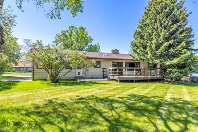 117 Henderson St, Bozeman, MT 59715 - back of house with a deck, a yard, and a chimney