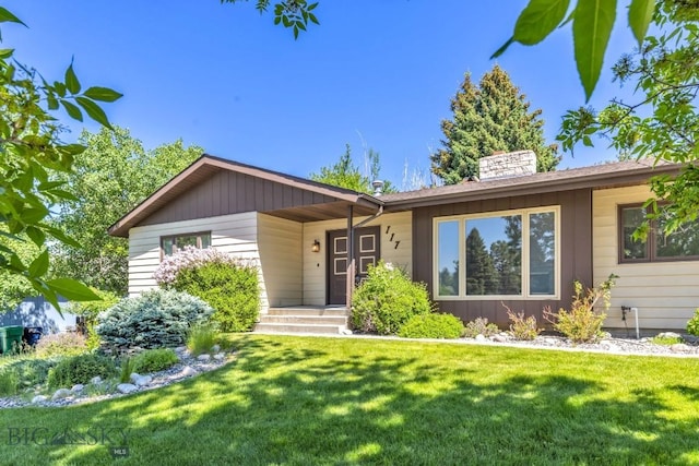 117 Henderson St, Bozeman, MT 59715 - ranch-style home featuring a front yard and a chimney