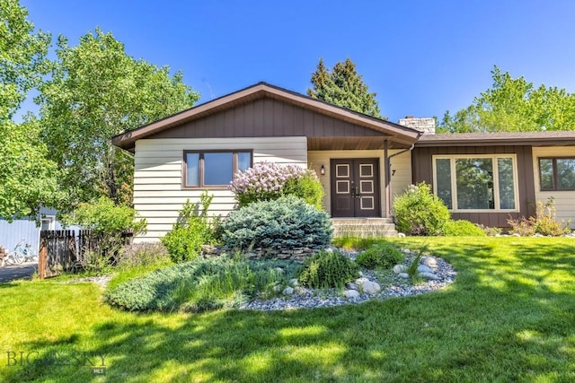117 Henderson St, Bozeman, MT 59715 - view of front of house featuring a front lawn and a chimney