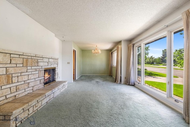 117 Henderson St, Bozeman, MT 59715 - unfurnished living room with carpet flooring, a textured ceiling, a fireplace, and a chandelier