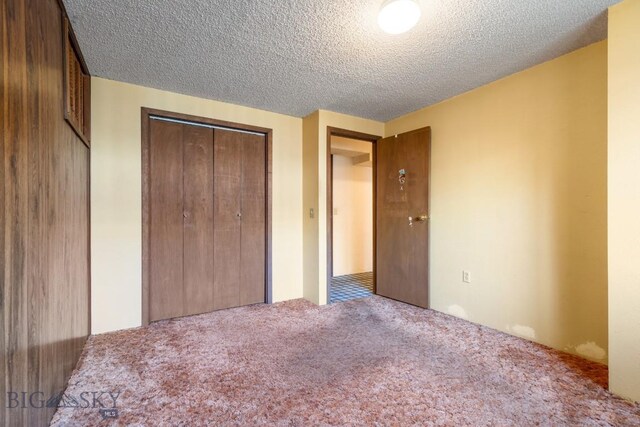 117 Henderson St, Bozeman, MT 59715 - unfurnished bedroom with carpet floors, a textured ceiling, and a closet
