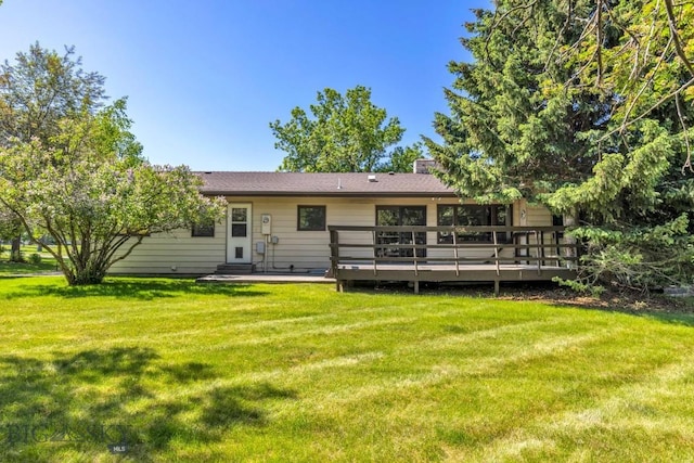 117 Henderson St, Bozeman, MT 59715 - rear view of house with a yard, a wooden deck, and a chimney