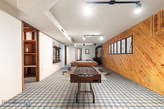 117 Henderson St, Bozeman, MT 59715 - hallway featuring wooden walls, carpet floors, rail lighting, and a textured ceiling