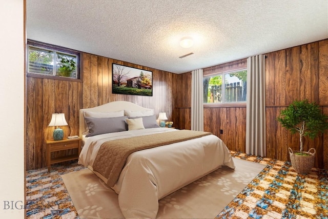 117 Henderson St, Bozeman, MT 59715 - bedroom featuring wood walls and a textured ceiling