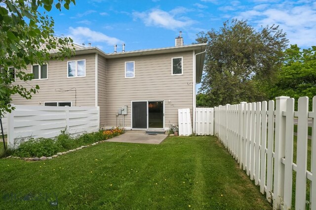 104 S Yellowstone Ave Unit 1, Bozeman, MT 59718 - back of property with a fenced backyard, a chimney, and a patio area