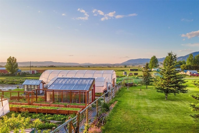 3573 Spain Bridge Rd, Belgrade, MT 59714 - view of grassy yard featuring an exterior structure, an outbuilding, a garden, and a mountain view