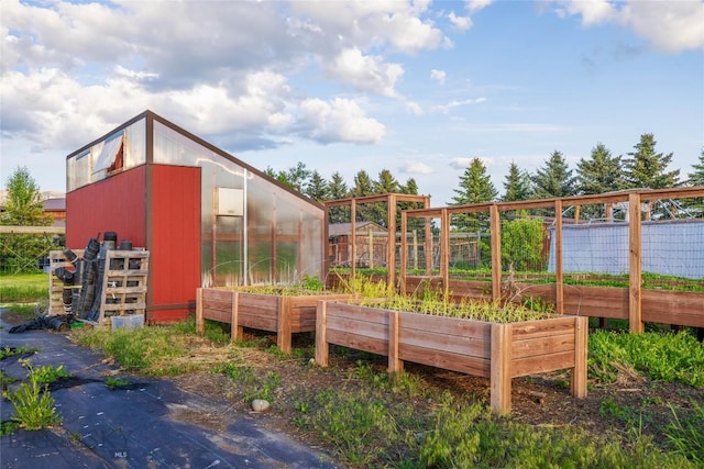 3573 Spain Bridge Rd, Belgrade, MT 59714 - wooden deck with a greenhouse, a garden, and an outdoor structure