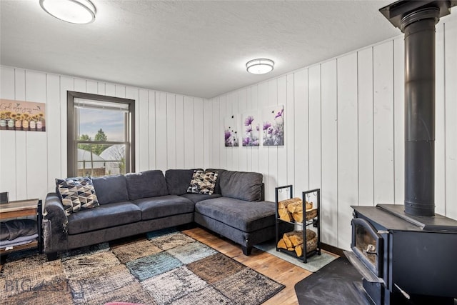 3573 Spain Bridge Rd, Belgrade, MT 59714 - living room with a wood stove, wood finished floors, and a textured ceiling