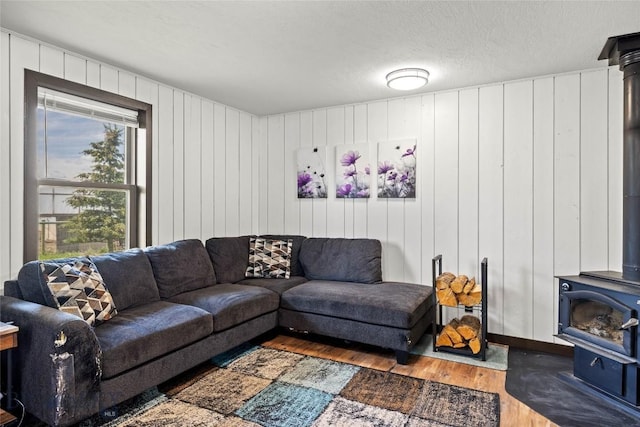 3573 Spain Bridge Rd, Belgrade, MT 59714 - living room featuring a wood stove, wood finished floors, and wooden walls