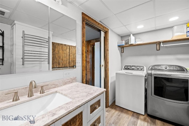 3573 Spain Bridge Rd, Belgrade, MT 59714 - washroom featuring independent washer and dryer, light wood-style flooring, radiator heating unit, and recessed lighting