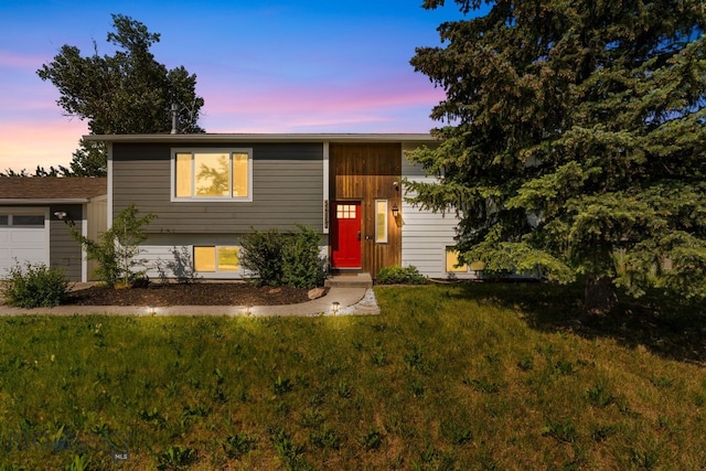 24151 Frontage Rd, Bozeman, MT 59718 - tri-level home featuring a front lawn and a garage