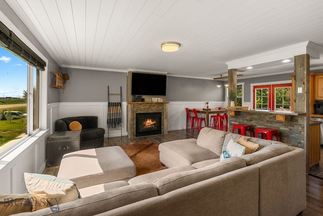 24151 Frontage Rd, Bozeman, MT 59718 - living room with wood finished floors, wainscoting, ornamental molding, and a lit fireplace