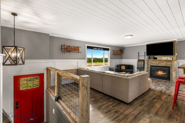 24151 Frontage Rd, Bozeman, MT 59718 - living area with a glass covered fireplace, dark wood-style flooring, a chandelier, a wainscoted wall, and crown molding