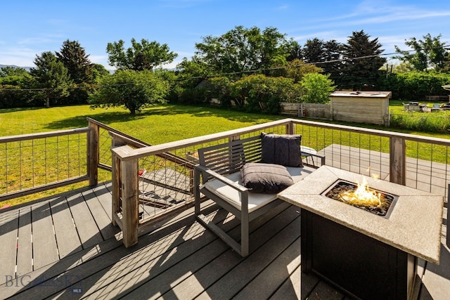 24151 Frontage Rd, Bozeman, MT 59718 - wooden terrace with a fire pit and a storage unit