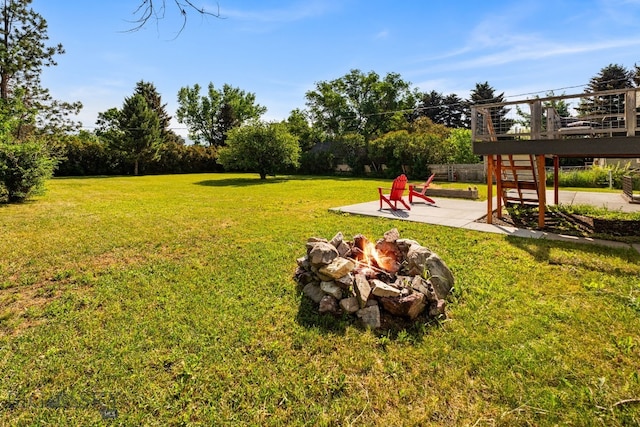 24151 Frontage Rd, Bozeman, MT 59718 - view of grassy yard with a fire pit, a patio, and a deck