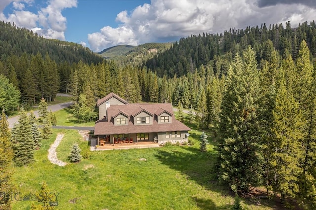 1255 Andesite Rd, Big Sky, MT 59716 - aerial view of property and surrounding area with a heavily wooded area and a mountainous background