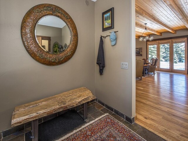 1255 Andesite Rd, Big Sky, MT 59716 - corridor with a chandelier and a wooden ceiling with exposed beams