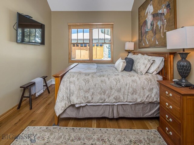 1255 Andesite Rd, Big Sky, MT 59716 - bedroom with wood finished floors and baseboards