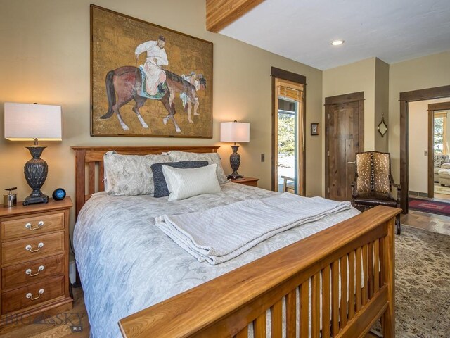 1255 Andesite Rd, Big Sky, MT 59716 - bedroom with multiple windows, wood finished floors, and recessed lighting