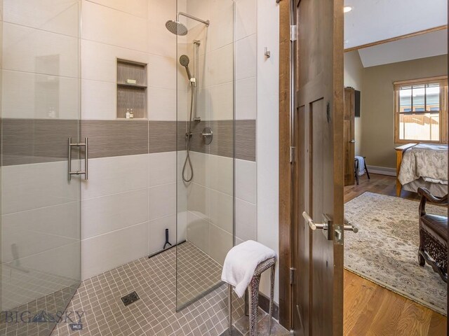 1255 Andesite Rd, Big Sky, MT 59716 - full bathroom with connected bathroom, wood finished floors, a shower stall, and vaulted ceiling