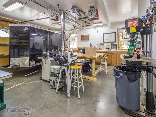 1255 Andesite Rd, Big Sky, MT 59716 - garage with a workshop area and a garage door opener