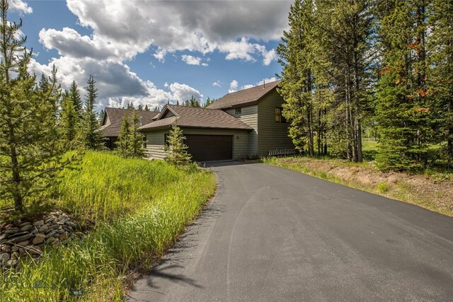 1255 Andesite Rd, Big Sky, MT 59716 - view of front of home featuring an attached garage and asphalt driveway