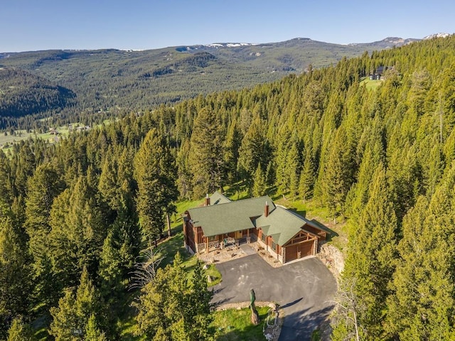 725 Sandhill Rd, Big Sky, MT 59716 - aerial view of property and surrounding area with a forest and a mountainous background