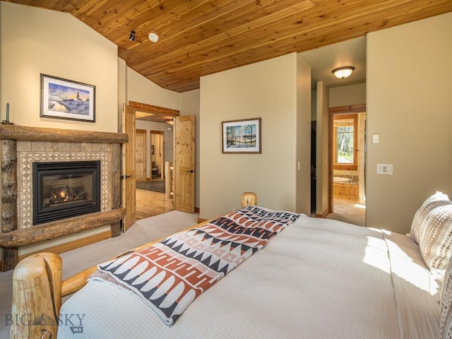 725 Sandhill Rd, Big Sky, MT 59716 - bedroom featuring wood ceiling, carpet floors, a tile fireplace, and vaulted ceiling