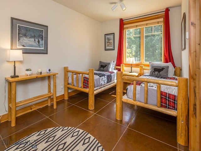 725 Sandhill Rd, Big Sky, MT 59716 - tiled bedroom featuring baseboards