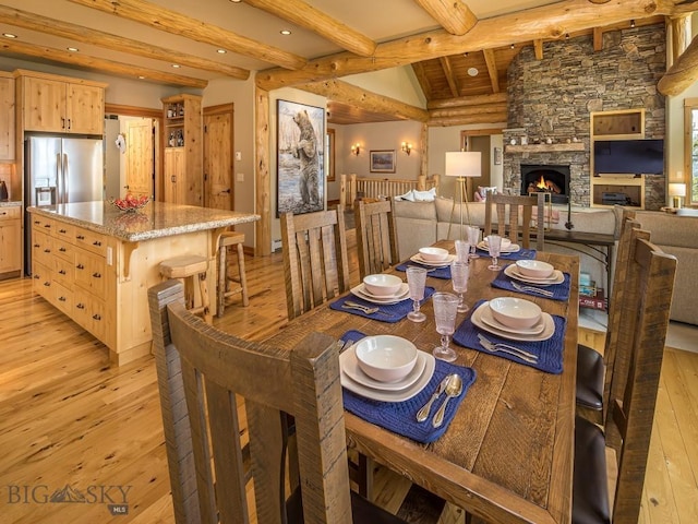 725 Sandhill Rd, Big Sky, MT 59716 - dining area with light wood-type flooring, a fireplace, and recessed lighting
