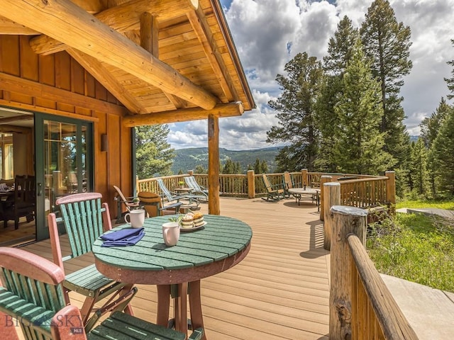 725 Sandhill Rd, Big Sky, MT 59716 - wooden terrace featuring a mountain view and outdoor dining area