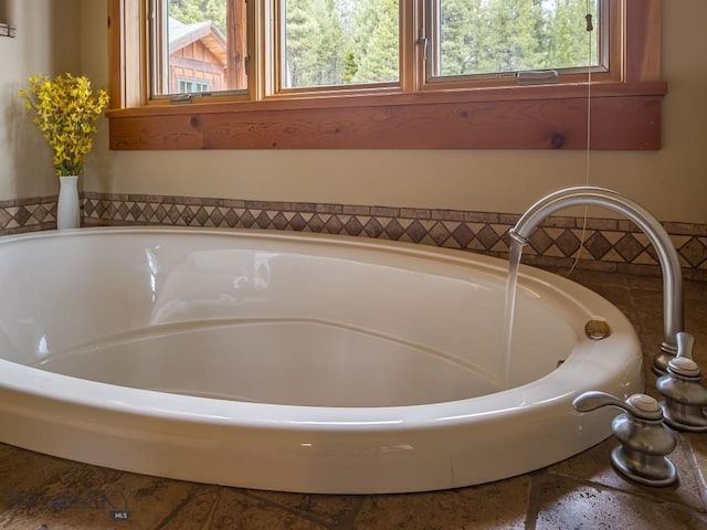 725 Sandhill Rd, Big Sky, MT 59716 - bathroom featuring a bath and plenty of natural light