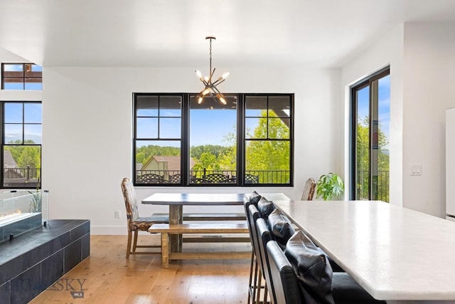 557 St Andrews, Bozeman, MT 59715 - dining room with light wood-type flooring and a chandelier