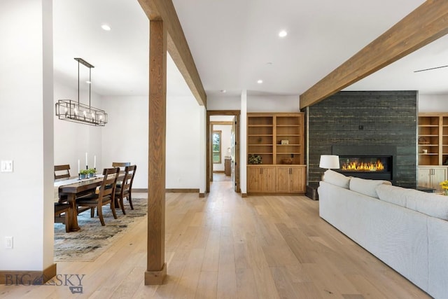 33 Leachman Ln, Bozeman, MT 59718 - living area with light wood finished floors, beam ceiling, a fireplace, and recessed lighting