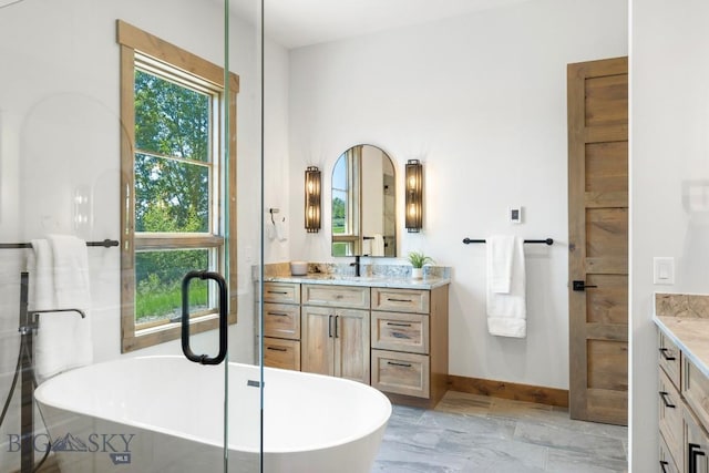 33 Leachman Ln, Bozeman, MT 59718 - bathroom featuring vanity, a freestanding bath, and marble finish floors