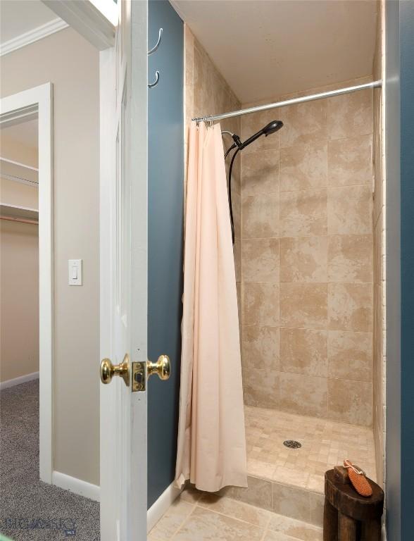 8373 Goldenstein Ln, Bozeman, MT 59715 - bathroom with a tile shower and baseboards