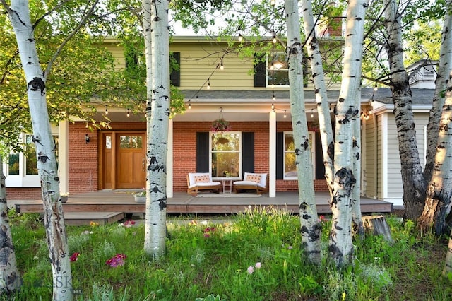8373 Goldenstein Ln, Bozeman, MT 59715 - view of front of house featuring brick siding and a porch