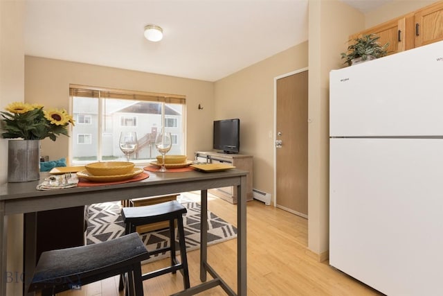 13 Moose Ridge Rd, Big Sky, MT 59716 - kitchen featuring freestanding refrigerator, baseboard heating, and light wood-style floors