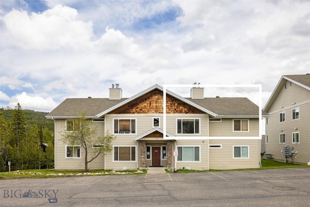 13 Moose Ridge Rd, Big Sky, MT 59716 - craftsman inspired home featuring a chimney, uncovered parking, and stone siding