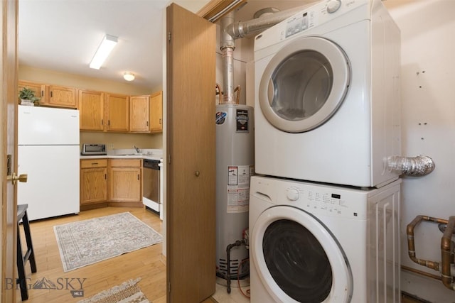 13 Moose Ridge Rd, Big Sky, MT 59716 - washroom featuring stacked washer and clothes dryer, water heater, and light wood-style flooring