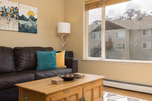 13 Moose Ridge Rd, Big Sky, MT 59716 - living area featuring a baseboard heating unit and wood finished floors
