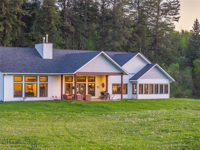 13011 Cottonwood Canyon Rd, Bozeman, MT 59718 - back of house featuring a chimney, a yard, and roof with shingles