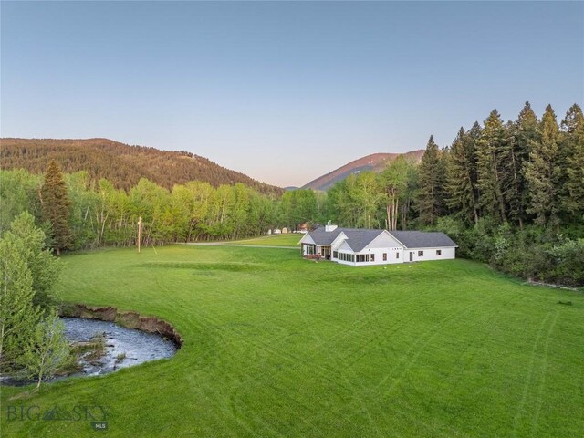 13011 Cottonwood Canyon Rd, Bozeman, MT 59718 - view of grassy yard featuring a view of trees and a mountain view