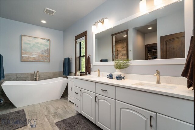13011 Cottonwood Canyon Rd, Bozeman, MT 59718 - full bath featuring double vanity, a soaking tub, tiled shower, recessed lighting, and tile walls
