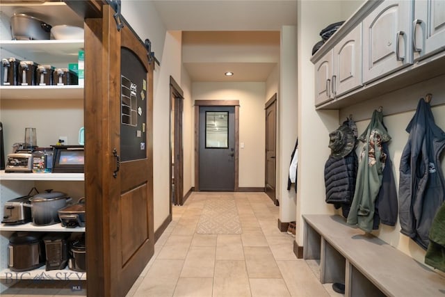 13011 Cottonwood Canyon Rd, Bozeman, MT 59718 - mudroom with light tile patterned floors, a barn door, and recessed lighting