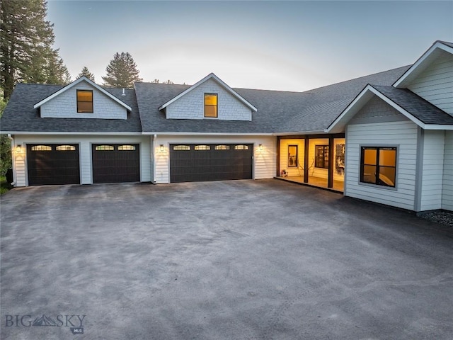 13011 Cottonwood Canyon Rd, Bozeman, MT 59718 - view of front facade featuring asphalt driveway, a garage, and a shingled roof