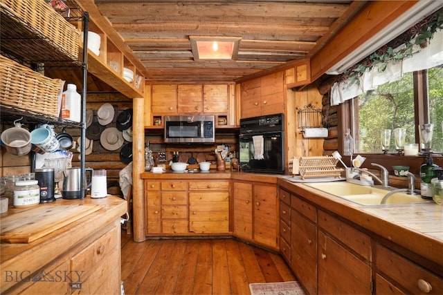 13011 Cottonwood Canyon Rd, Bozeman, MT 59718 - kitchen with oven, stainless steel microwave, light wood-style flooring, wooden ceiling, and brown cabinets