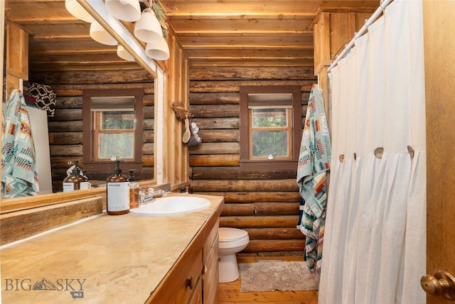 13011 Cottonwood Canyon Rd, Bozeman, MT 59718 - full bathroom with log walls, vanity, wood ceiling, and wood finished floors