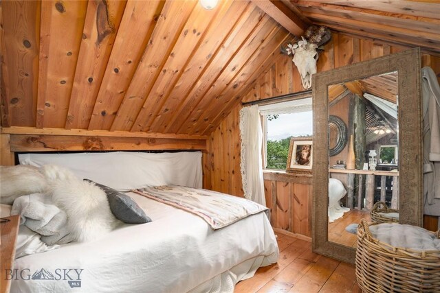 13011 Cottonwood Canyon Rd, Bozeman, MT 59718 - bedroom featuring lofted ceiling, wooden walls, and hardwood / wood-style flooring