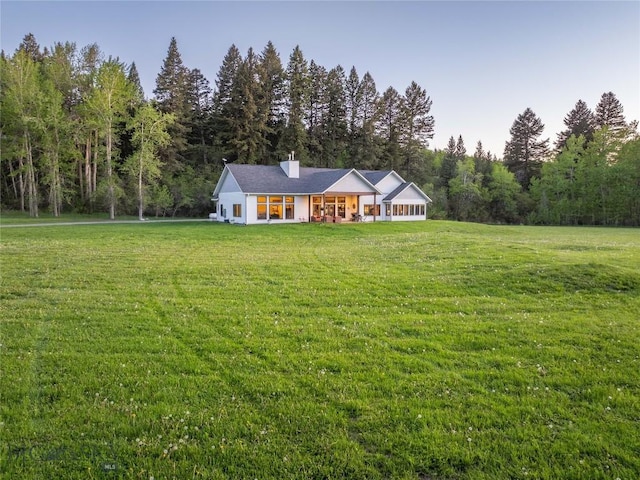 13011 Cottonwood Canyon Rd, Bozeman, MT 59718 - ranch-style home featuring a front yard, a view of trees, and a chimney